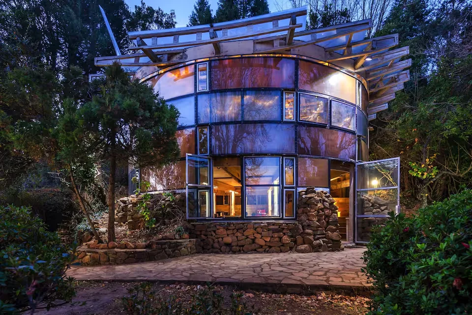 The Lantern glass cottage, surrounded by forest